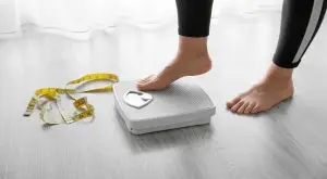 xrdDAF_U7WFuwk5j2120490997036820483t24031219 - Elevate Integrative Wellness - Elevate Integrative Wellness weight loss image, woman standing on a scale